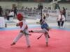 Dua atlet cilik saling adu teknik dalam pertandingan Liga Taekwondo Pelajar Indonesia 2025 di GOR Indoor Kelapa Dua, Tangerang.
